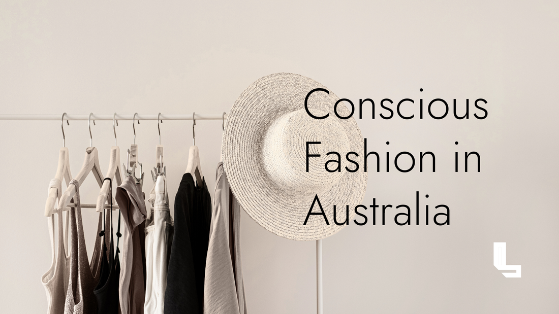 Neutral-toned clothing rack with natural fabric garments and a straw hat, representing conscious fashion and slow clothing choices in Australia.
